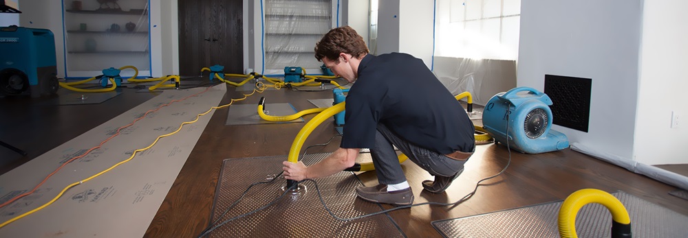 a man is washing office with machines to remove smoke odor